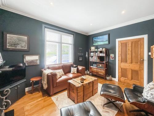 a living room with a couch and a table at Taigh Beag in Stranraer