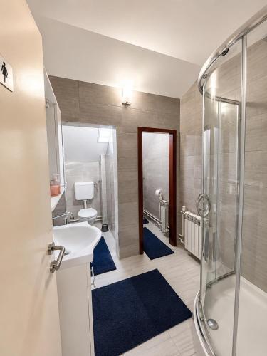 a bathroom with a sink and a shower at Hostel Suzzzy in Novska