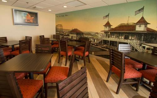 a restaurant with tables and chairs and a painting on the wall at The Inn on Lake Superior in Duluth