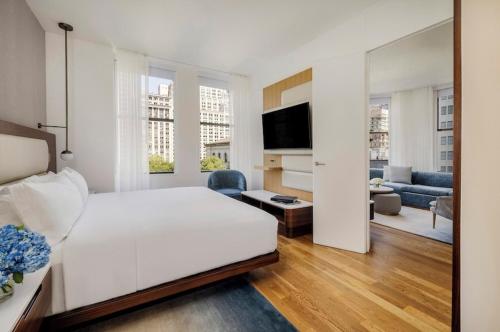 a bedroom with a white bed and a living room at FERRY HOUSE stranraer in Stranraer