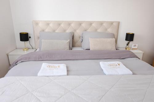 a large bed with two white pillows on it at Apartman Centar in Teslić