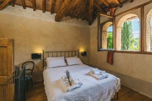 a bedroom with a bed with towels on it at La Pimpinella di Semifonte in San Donnino