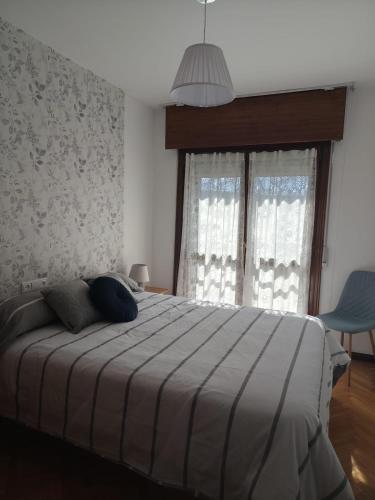 a bedroom with a large bed and a window at La Royana in Vinuesa