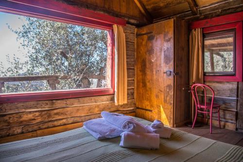 a bedroom with a bed and a window and a chair at Casa Del Sole in Camaiore