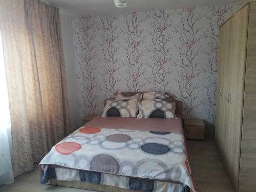 a small bedroom with a bed in a room at Cazare Adda Body in Corbu
