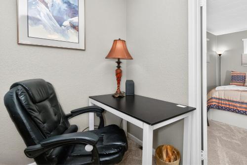 a room with a chair and a desk with a lamp at 404 Doc Susie home in Fraser