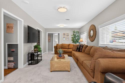 a living room with a brown couch and a table at 404 Doc Susie home in Fraser