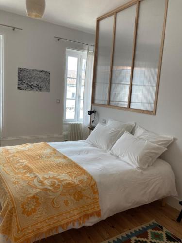 a bedroom with a large bed with white sheets and pillows at Maralocquet in Barbezieux-Saint-Hilaire