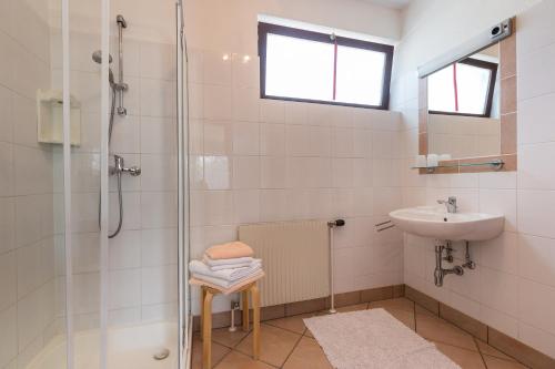 a bathroom with a shower and a sink at Haus Helene in Mörbisch am See