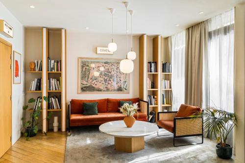 a living room with a couch and a table at Hôtel Oratio in Paris