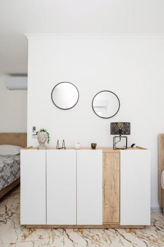 a bedroom with white cabinets and a bed at Villa Kaplan Verde in Stolac