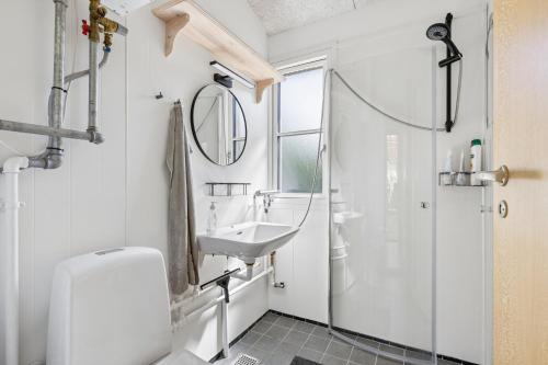 a bathroom with a sink and a shower at Close To The Beach With Outdoor Spa in Slagelse