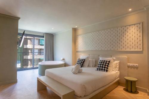 a bedroom with a large bed and a window at AT Boutique Alma in Alicante