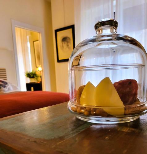 a glass jar with food in it on a table at La Dimora dell'Arte in Bari