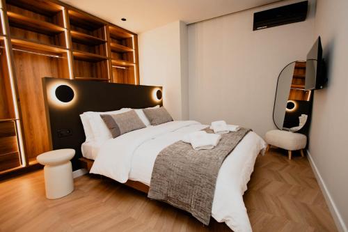 a bedroom with a large bed and a television at Maison Sidra in Thessaloniki