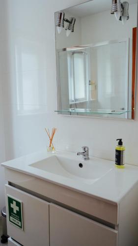 a bathroom with a sink and a mirror at City Centre Cozy Apartment in Porto