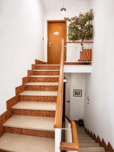 a staircase in a house with a wooden door at Bellavista in Coazze