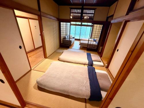 a small room with two beds in it at SADO Stay 02 金山京町一軒家貸し切り in Sado