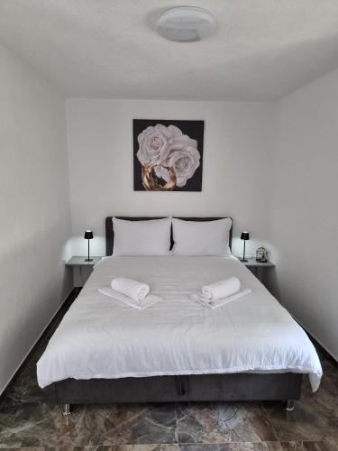 a bedroom with a bed with two towels on it at Apartmani Lucica in Jajce