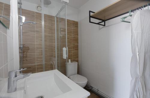 a bathroom with a toilet and a sink and a shower at Studio à 50 m de la plage in Arcachon