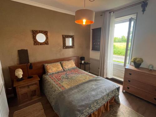 a bedroom with a bed and a large window at Appartement Saint Antoine 2 in Toulon-sur-Arroux