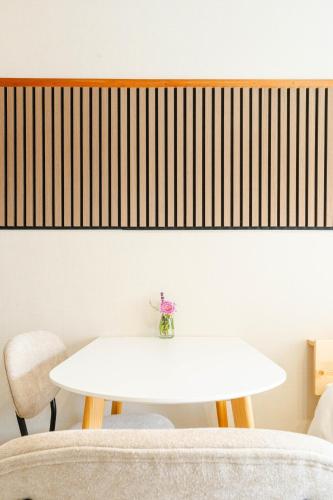 a white table and chairs in a room at Maison Atago201 in Fukuoka