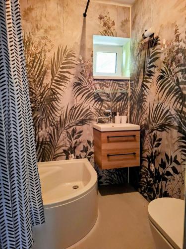 a bathroom with a bath tub and a sink at Ohrazenice 103 in Turnov