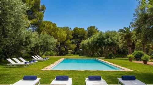 a swimming pool in a yard with lounge chairs at Masia Sitges Mas Peirot Geniune Farmhouse 20 min walk from beaches 60 Heactares of Wine Fields Garden AC Until 18 people in Cubelles