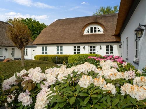 a white house with flowers in front of it at Holiday Home Jolanda by Interhome in Bramming