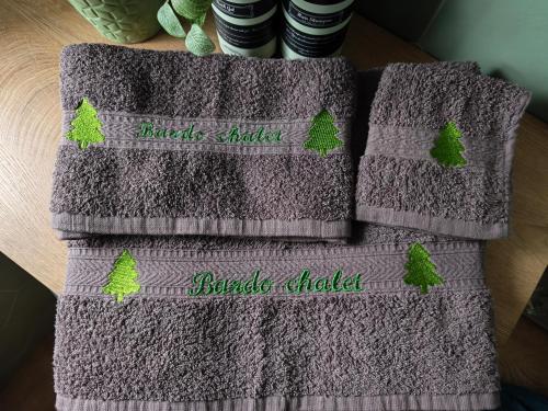 two towels with trees on them sitting on a table at Bardo Chalet in Bardonecchia