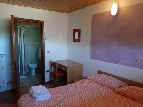 a bedroom with a bed and a sink and a toilet at Albergo Alpino Cheggio in Alpe Cheggio