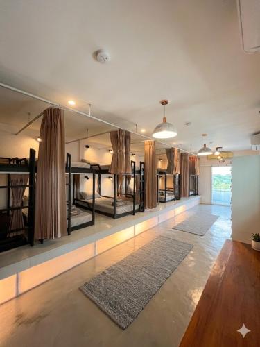 a room with several bunk beds and a rug at The Retreat Hotel Wellness & Spa in Krabi