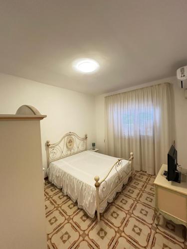 a bedroom with a bed and a television in it at Da mare in Ginosa Marina