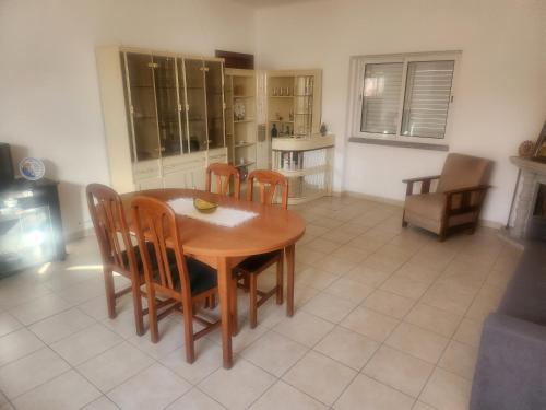 a kitchen and dining room with a table and chairs at House Proença in Ladoeiro