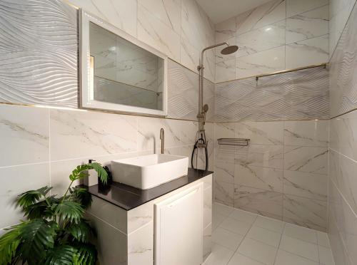 a white bathroom with a sink and a shower at Casa Phangan - Boutique Island Villa in Wok Tum