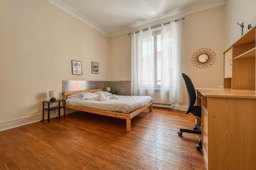 a bedroom with a bed and a desk and a window at #EU L'Authentique in Grenoble