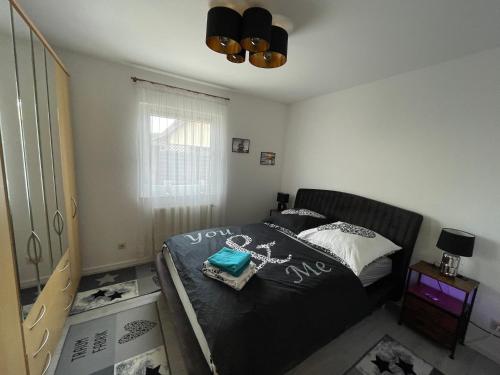 a bedroom with a bed with a black comforter at Haus Sonnenschein in Koserow