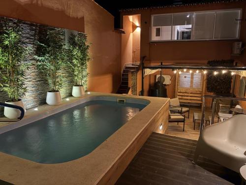 a bathroom with a jacuzzi tub and a sink at Casa Velha in Mourão