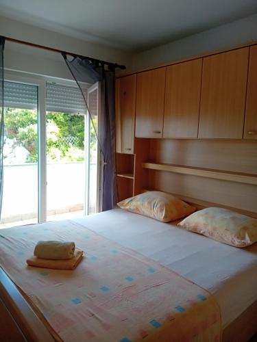 a bedroom with a large bed with two pillows at Matteo in Supetarska Draga