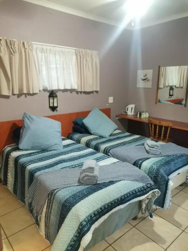 two beds sitting next to each other in a room at My Serenity Guesthouse in Mokopane
