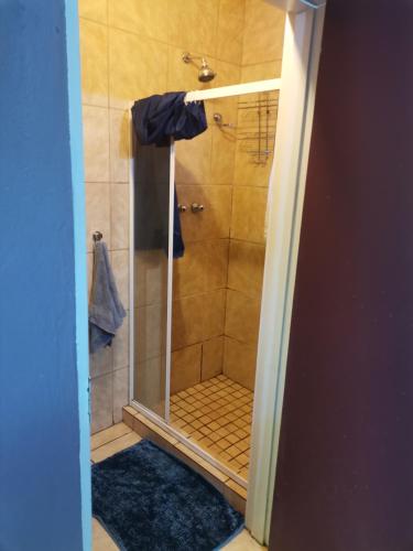 a bathroom with a shower with a glass door at My Serenity Guesthouse in Mokopane