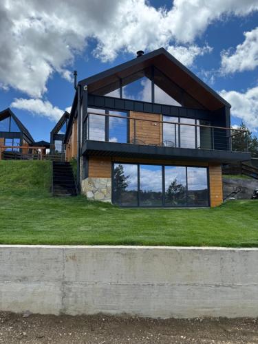 a house on a hill with large windows at Vamas Villa in Dobroselica