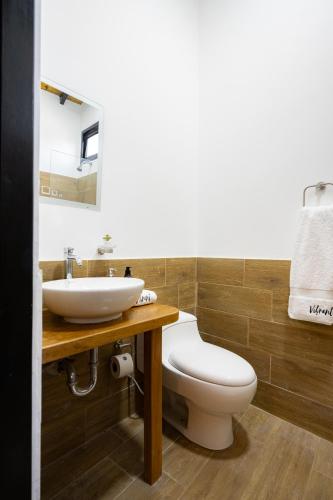 a bathroom with a toilet and a sink at Casa Arte by Vibrant in Vichayito