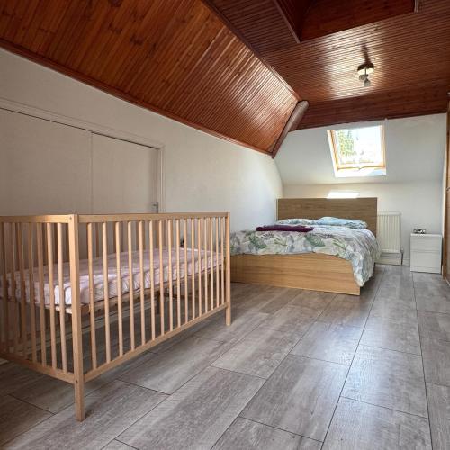 a bedroom with a bed and a wooden ceiling at Instant Home in Luton