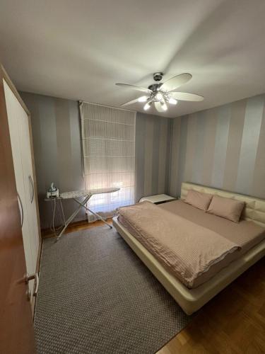 a bedroom with a bed and a ceiling fan at Bar Luxury Apartment in Bar