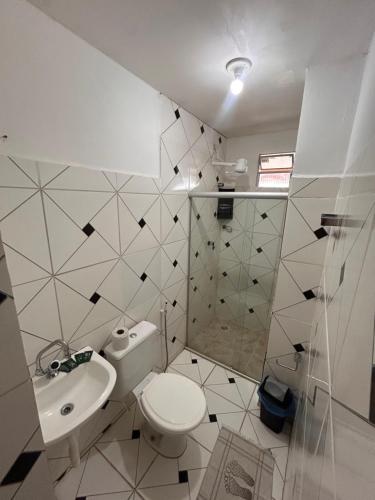 a bathroom with a toilet and a sink and a shower at Pousada Recanto Paradise in Porto De Galinhas
