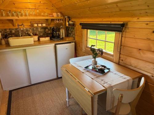 a small kitchen with a wooden table and a table sidx sidx sidx at Le kota des 3 tilleuls in Dampierre-sur-Salon