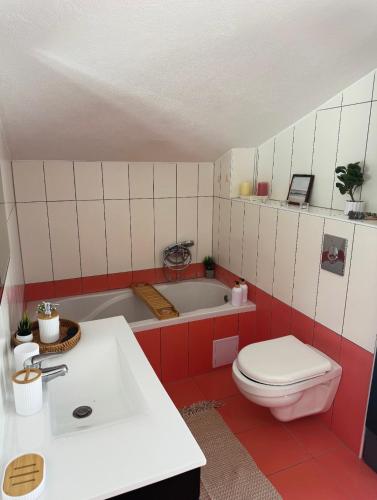 a bathroom with a tub and a toilet and a sink at Villa with stunning Mountain Views and Authentic Croatian Stone House near Split and Sea in Žrnovnica