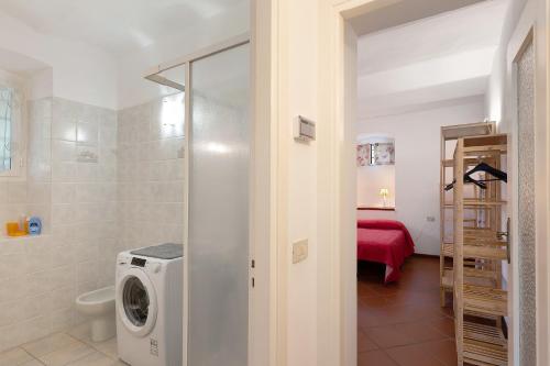 a bathroom with a washing machine in a room at Casa Lena in Arma di Taggia