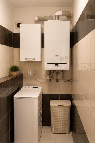 a bathroom with a toilet and a sink and mirror at Apartman Pred polom in Trenčín